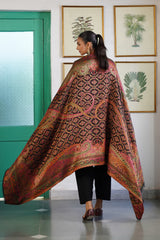 Close-up of jewel-tone paisley motif on woven shawl