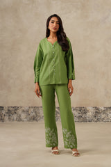 Woman wearing green linen co-ord set with embroidered pants