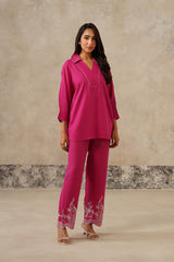 Woman wearing hot pink collared co-ord set with cutwork embroidered pants