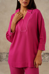 Detail of contrast stitch detailing on fuchsia linen shirt