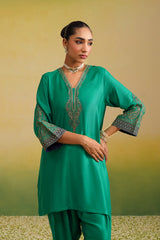Woman in emerald green embroidered co-ord set, front profile