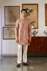 Man wearing peach kani paisley kurta with cream pants