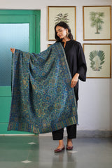 Woman draped in teal blue mandala wool shawl for festive wear