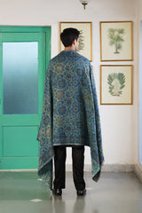 Teal blue floral shawl draped over shoulder for festive occasion