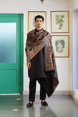 Woman draped in jewel tone Kani paisley shawl, luxury gift