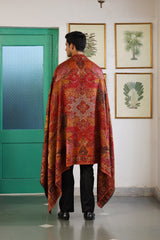 Couple wearing deep red and beige jacquard shawls together