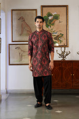 Maroon paisley jamawar Nehru jacket over black kurta and pants, front view