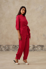 Woman wearing rani pink satin shirt pant set, side view