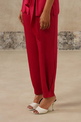Close-up of ankle seam detail on rani pink satin trousers