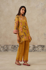 Woman wearing yellow floral printed co-ord set with dupatta, side angle