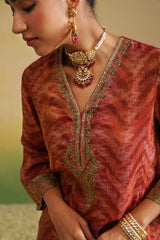 close up of embroidered neckline on rust print set