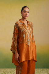 Woman in rust paisley printed kurta set, front profile