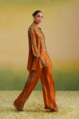 Rust co-ord set styled with wide-leg paisley printed pants
