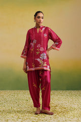 Woman wearing pink floral printed tissue co-ord set with striped salwar