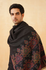 Black motif wool shawl draped over shoulder for festive wear